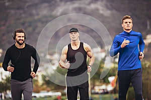 Athletes practicing a run on athletics stadium track