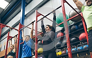 Athletes ready to do pull ups in the box