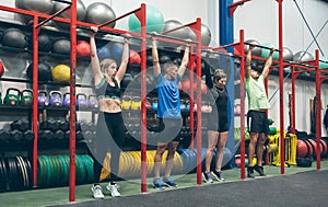 Athletes ready to do pull ups in the box