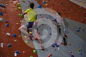 Athletes rock climbing in fitness studio