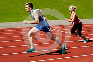 Athletes running on race track