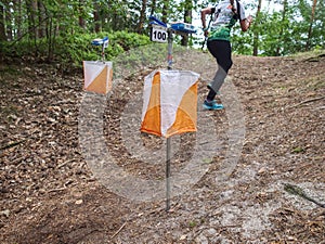 Athletes rush to the checkpoint on the trail through forest