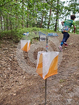 Athletes rush to the checkpoint on the trail through forest