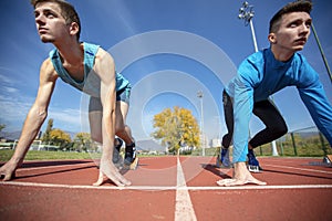 Athletes at the sprint start line in track and field