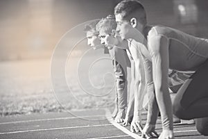 Athletes at the sprint start line in track and field