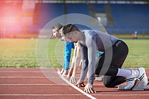 Athletes at the sprint start line in track and field