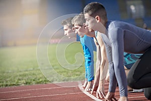 Athletes at the sprint start line in track and field