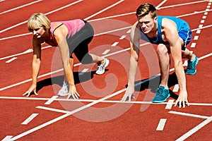 Athletes at starting line on race track photo