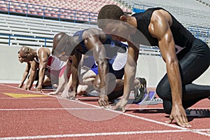 Athletes At A Starting Line On Racetrack