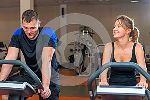 Athletes training on exercise bikes at gym