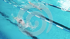 Athletes using butterfly technique to swim