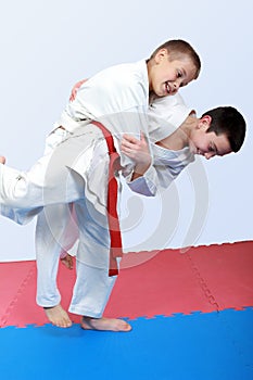 Athletes with a white and red sash do judo throw