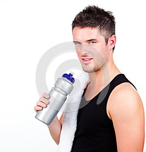 Athlethic young man holding a sports bottle