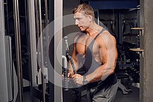 Athletic, adult man exercising in the gym