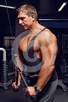 Athletic, adult man exercising in the gym