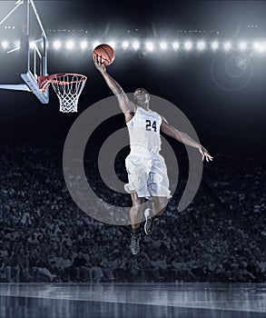 Athletic African American Basketball Player scoring a basket photo