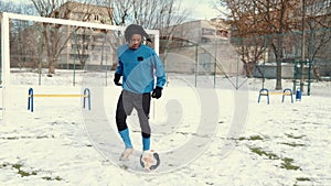 Athletic african american sportsman playing with soccer ball