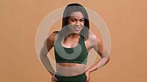 Athletic African Woman Showing Biceps Muscles Posing Over Beige Background