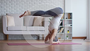 Athletic Asian woman practice yoga bow or dhanurasana pose to meditation in bedroom after wake up in the morning Feeling so