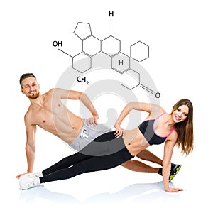 Athletic attractive couple - man and woman doing fitness exercises with the chemical formula on background - concept of healthy l