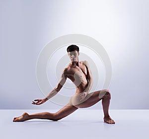 Athletic ballet dancer in a perfect shape performing