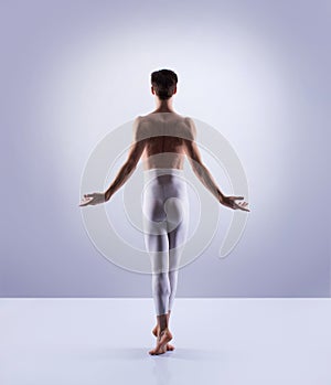 Athletic ballet dancer performing in a studio