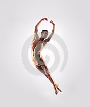 Athletic ballet dancer performing in a studio