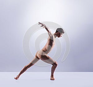 Athletic ballet dancer performing in a studio