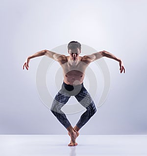 Athletic ballet dancer performing in a studio