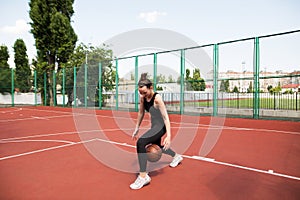 Athletic basketball player dribbles the ball on the basketball field photo