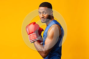 Athletic african fighter demonstrating classical boxing stance