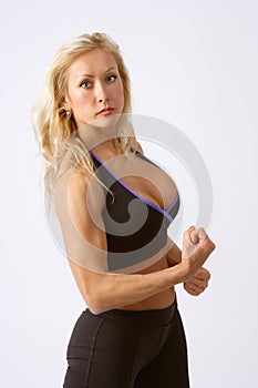 Athletic blonde girl showing her muscles