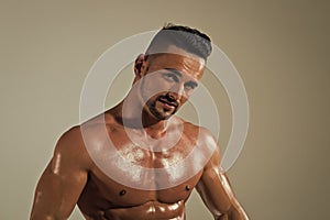 Athletic bodybuilder man on grey background.