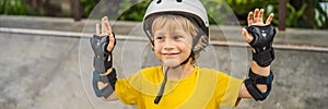 Athletic boy in helmet and knee pads learns to skateboard with in a skate park. Children education, sports BANNER, LONG