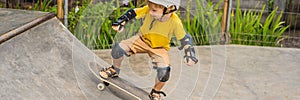 Athletic boy in helmet and knee pads learns to skateboard with in a skate park. Children education, sports BANNER, LONG