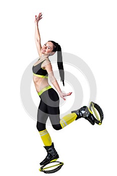 Athletic brunette girl jumping in a kangoo jumps shoes.