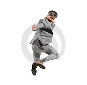 Athletic businessman in smart suit leaping in the air