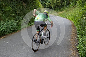 Athletic caucasian man eats protein on bicycle in nature