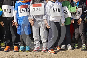 Athletic children ready to start a cross country race. Outdoors