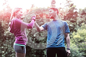 Athletic couple holding hands in forest