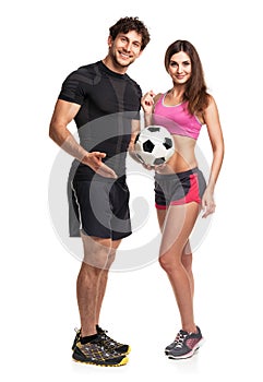 Athletic couple - man and woman with ball on the white