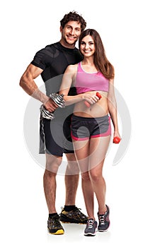 Athletic couple - man and woman with dumbbells on the white