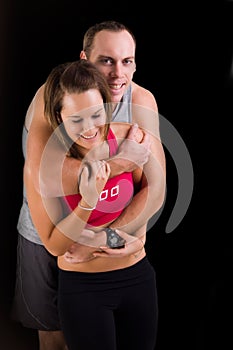 Athletic couple in playful hug