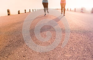 Athletic Couple woman jogging and running outdoors on road in the morning