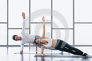 Athletic couple workout  with planking together in gym and fitness center