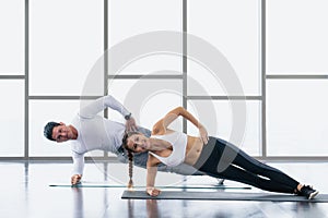 Athletic couple workout  with planking together in gym and fitness center