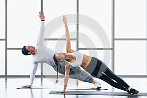 Athletic couple workout  with planking together in gym and fitness center