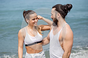 Happy caucasian couple having fun together on the ocean beach photo