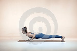 Athletic female practice yoga doing Low Plank exercising for healthy spine. Sport exercising workout, women's health