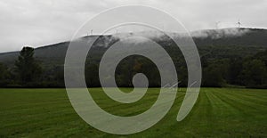 Athletic field in Vermont showing wind towers on mountaintop photo